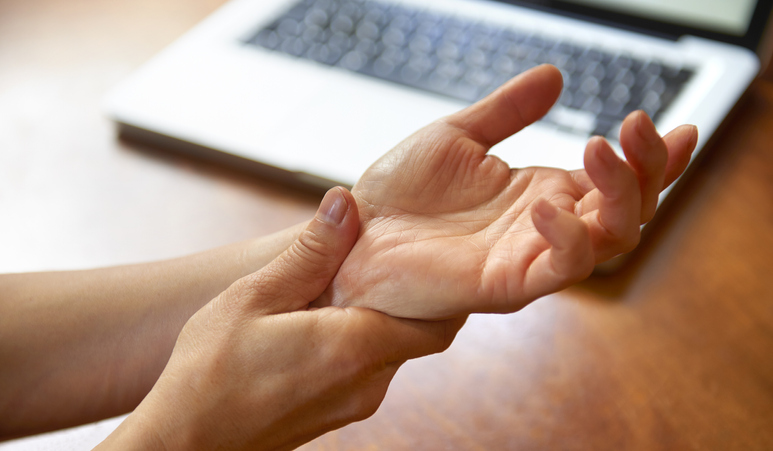 Photo shows woman massaging painful wrist