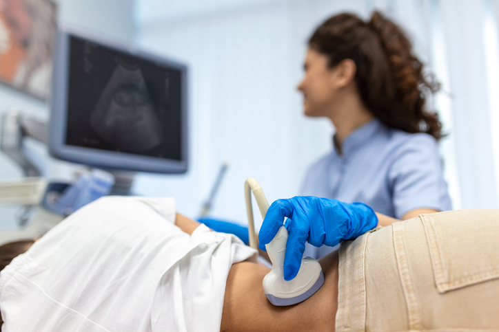 Photo shows doctor conducting ultrasound examination of patient