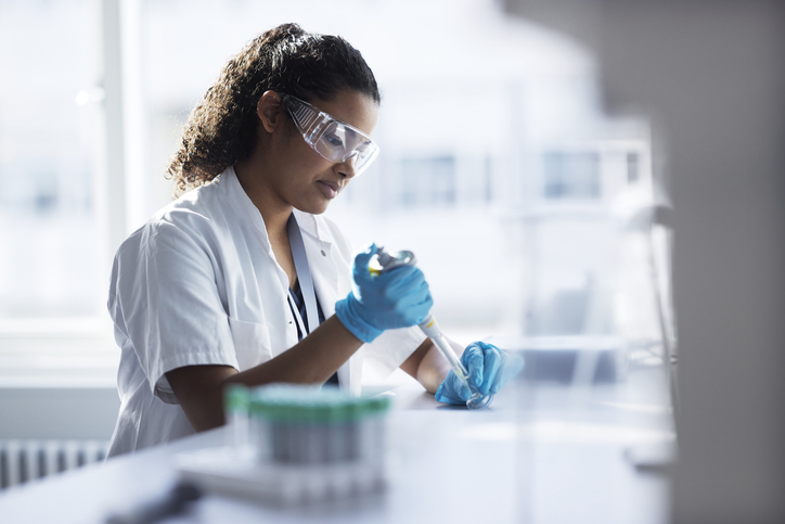 Photo shows a young female scientist working in a laboratory/Getty Images