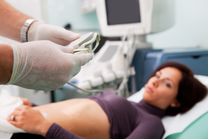 Photo shows doctor preparing to perform a liver biopsy/Getty Images