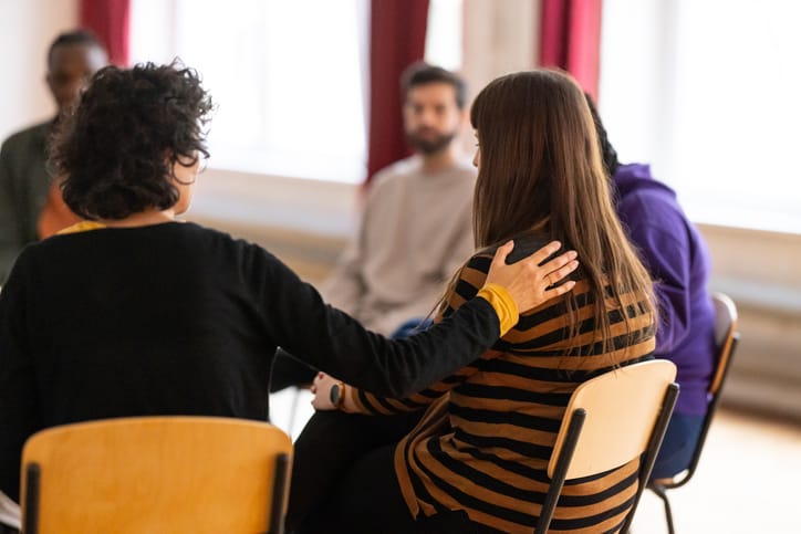 Photo shows people supporting each other